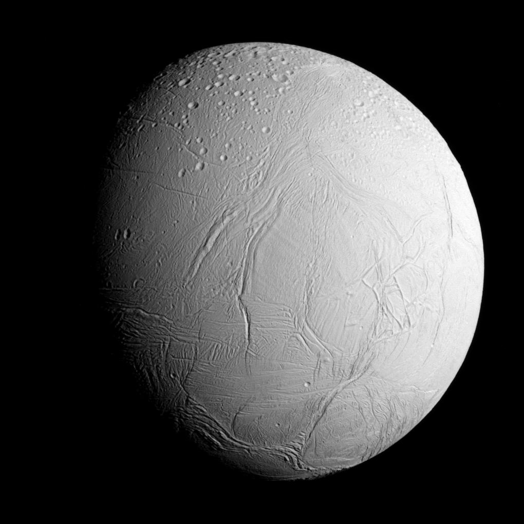 Enceladus, a bright icy moon covered in long cracks