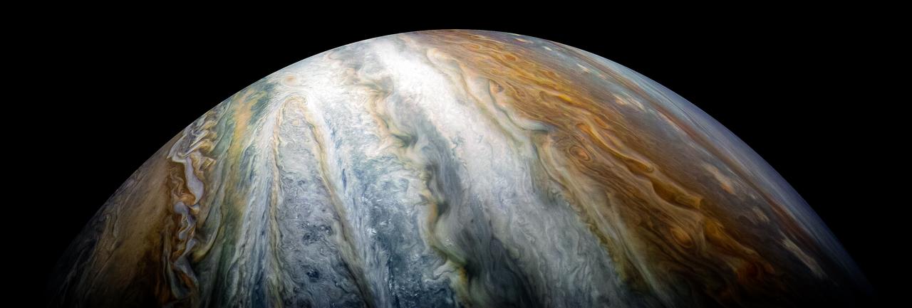 Jupiter's swirling bands of white, orange, and brown clouds