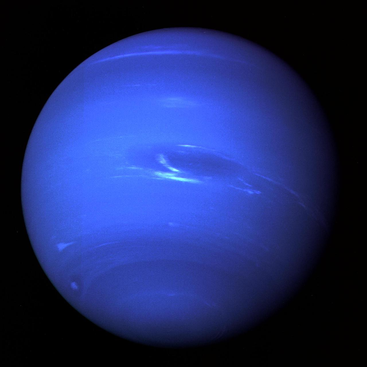 Neptune, a deep blue planet with bright wispy clouds