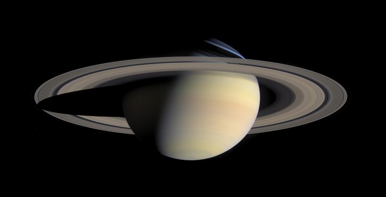 Saturn, a pale yellow planet with wide bright rings