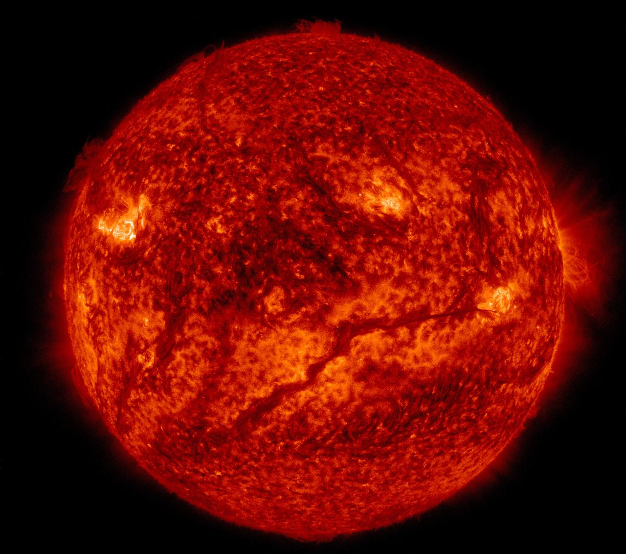 The Sun seen by a special camera as a bright red-orange ball with flares