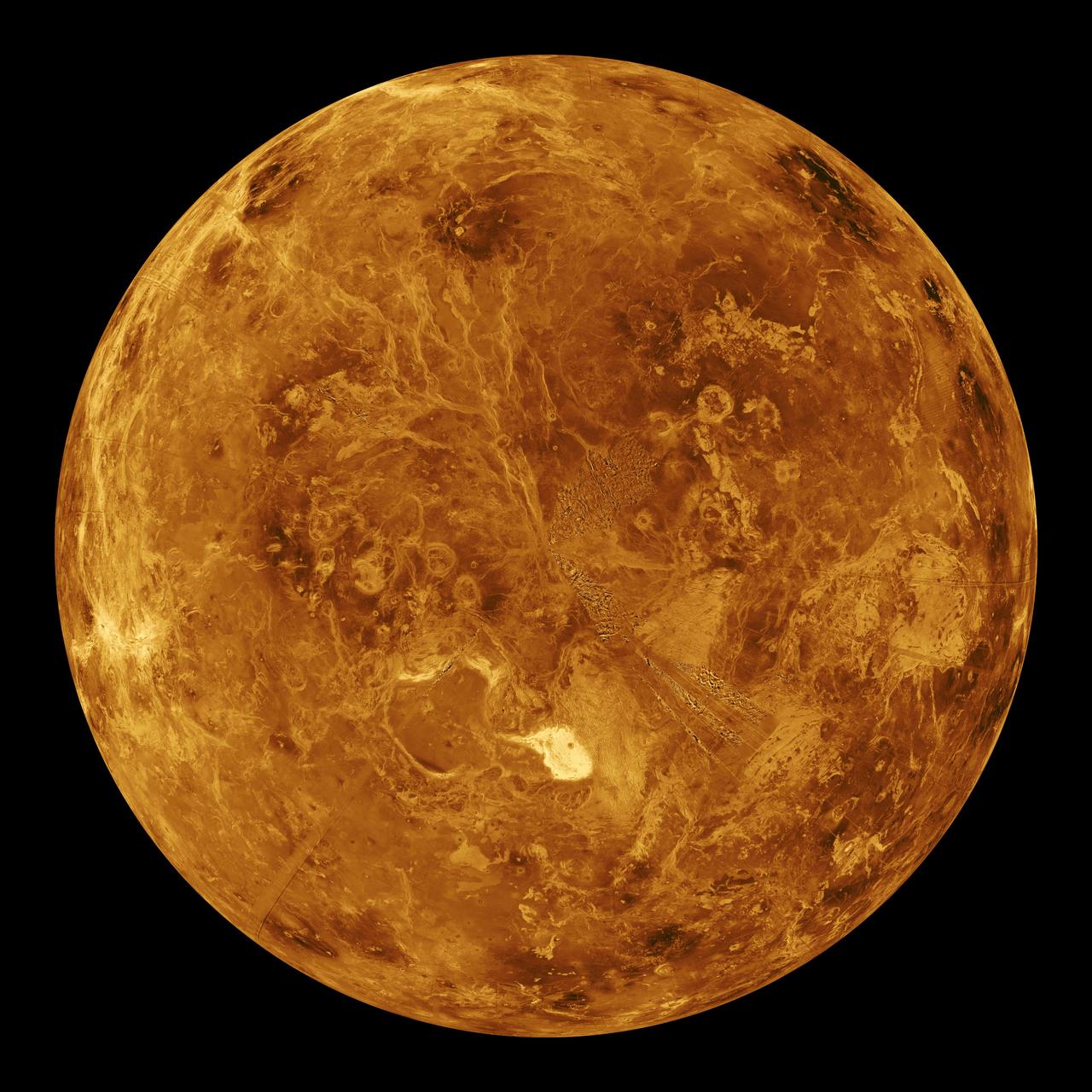 A golden radar map of Venus showing mountains and craters under the clouds